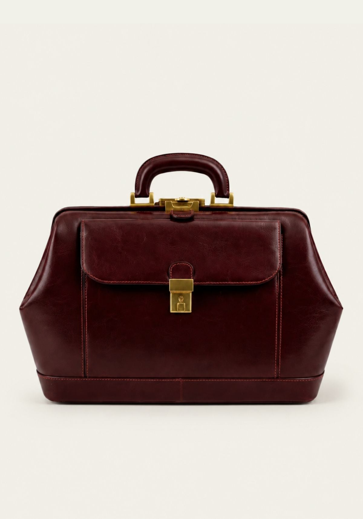 Bordeaux leather doctor’s bag with front flap, lock and handle in front view.