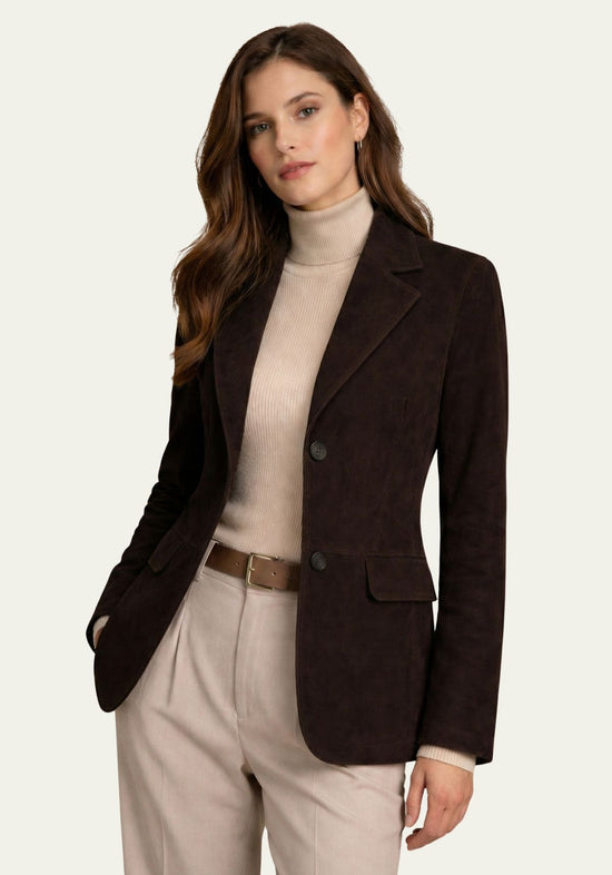 Women's blazer in suede, dark brown, worn by a woman with a roll-neck top and trousers.