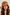 Brown sheepskin cap for women, worn frontally on a model, with a brim and soft pile texture.