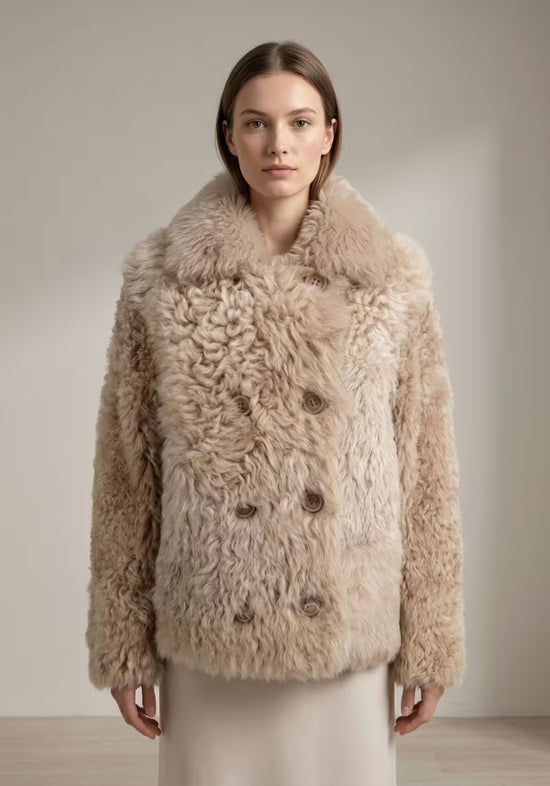Beige women’s curly sheepskin jacket shown on a model in front view against a grey background.