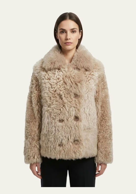 Beige women’s curly sheepskin jacket shown worn on a model from the front.
