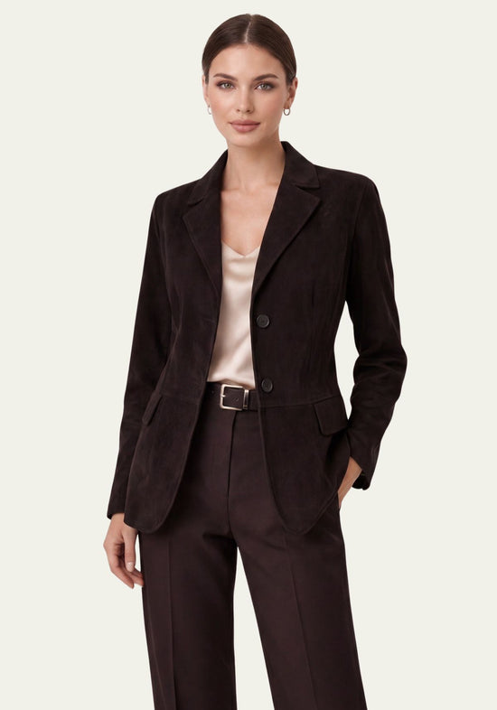 Black women's jacket in suede worn on the model, open over a blouse and trousers.