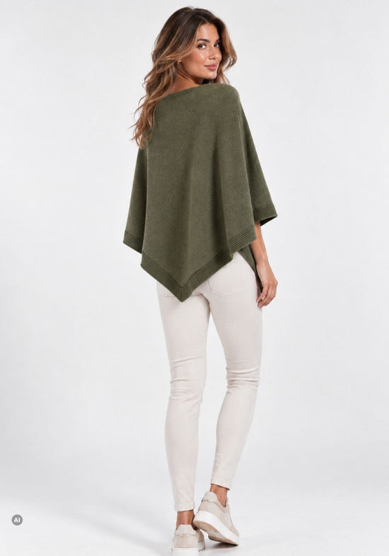 Women’s cashmere poncho in olive worn from the back, with a pointed hem and wide drape