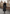 Black women’s sheepskin coat worn in full-length view on cobblestones