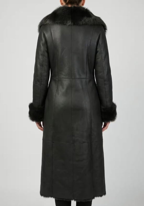 Worn rear view of the black women’s sheepskin coat with fur collar and cuffs