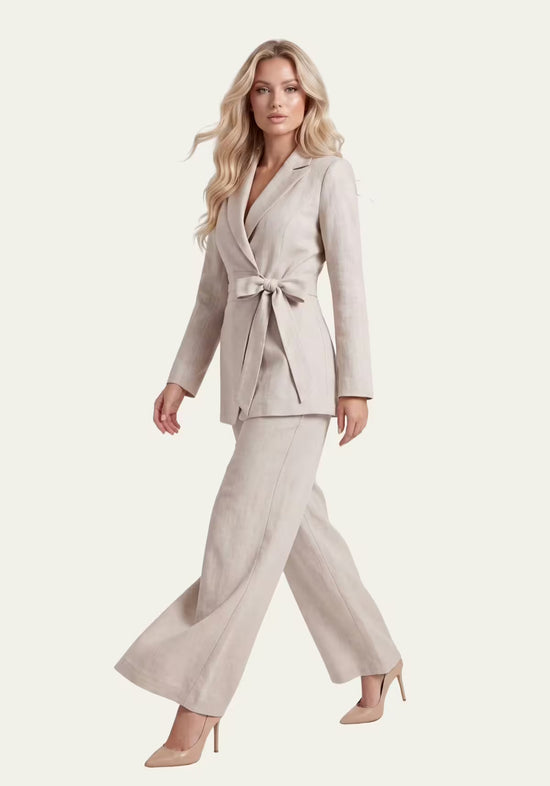 Women's linen set in beige, shown from the side with wrap blazer and palazzo trousers.