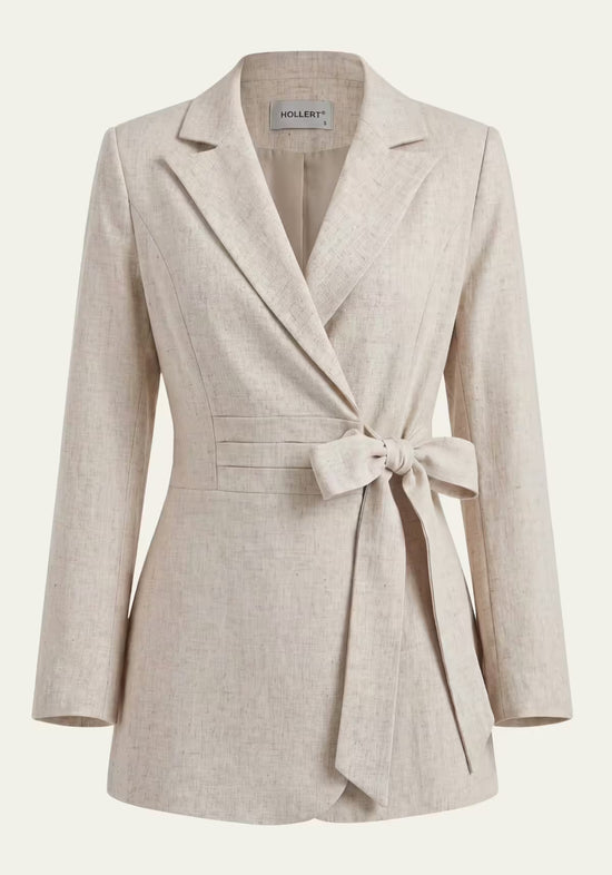 Beige women's wrap blazer in linen with tie belt, shown freestanding from the front.