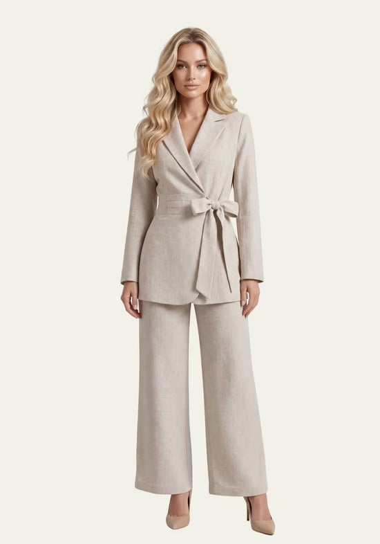 Women's wrap blazer and palazzo trousers in beige linen, shown worn in a full-length view.