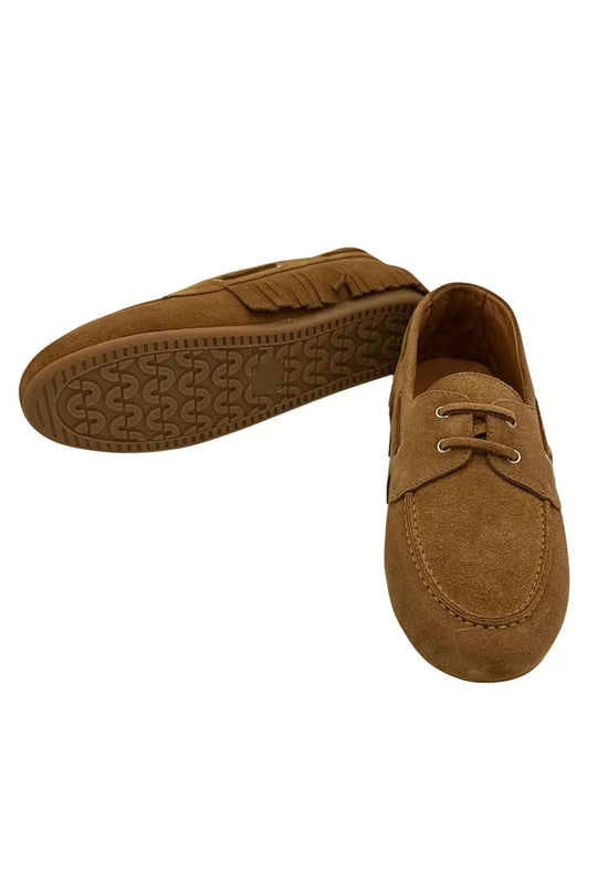 Women’s moccasin shoes in camel leather with patterned outsole and fringe detail.