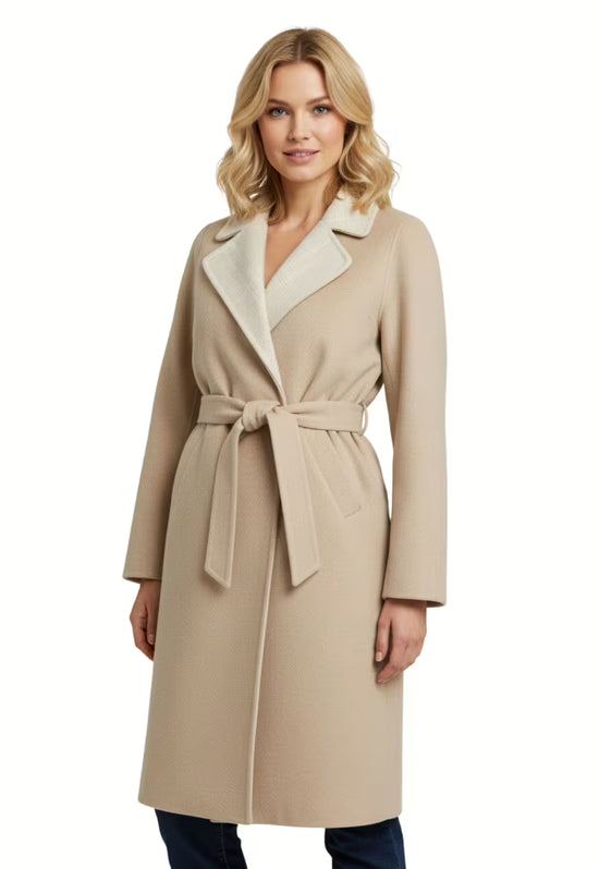Beige women's wool coat with tie belt, open lapels and straight cut, worn by a woman.