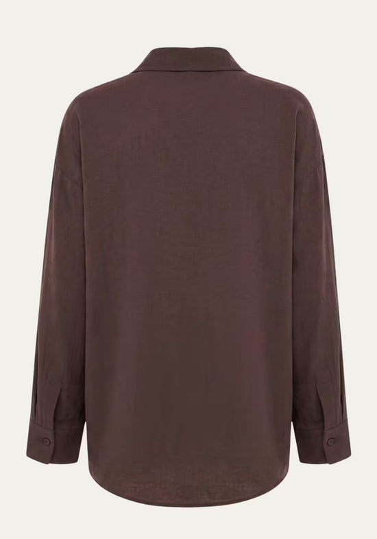 Rear view of the brown women’s linen shirt with a loose fit and long sleeves.