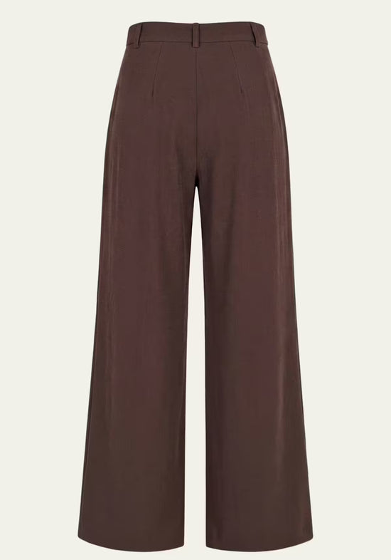 Rear view of the brown women’s linen trousers with waistband, belt loops and wide legs.