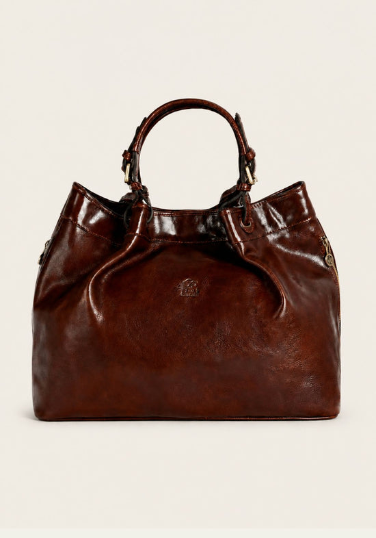 Brown leather handbag shown from the front with twin handles and a glossy finish.