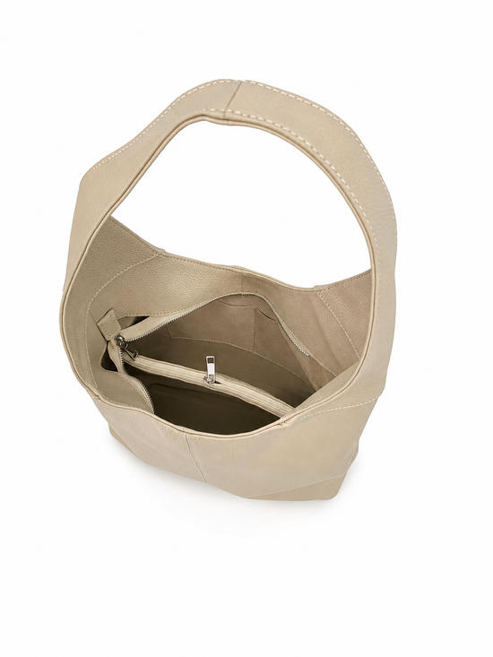 Interior view of the cream-beige leather handbag with zipped pocket and open main compartment.