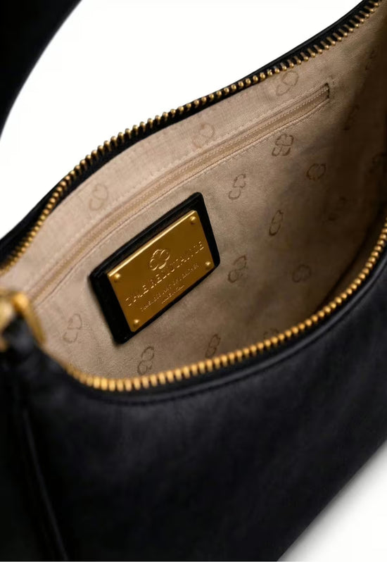 Interior view of the black leather handbag with lining and zipped pocket