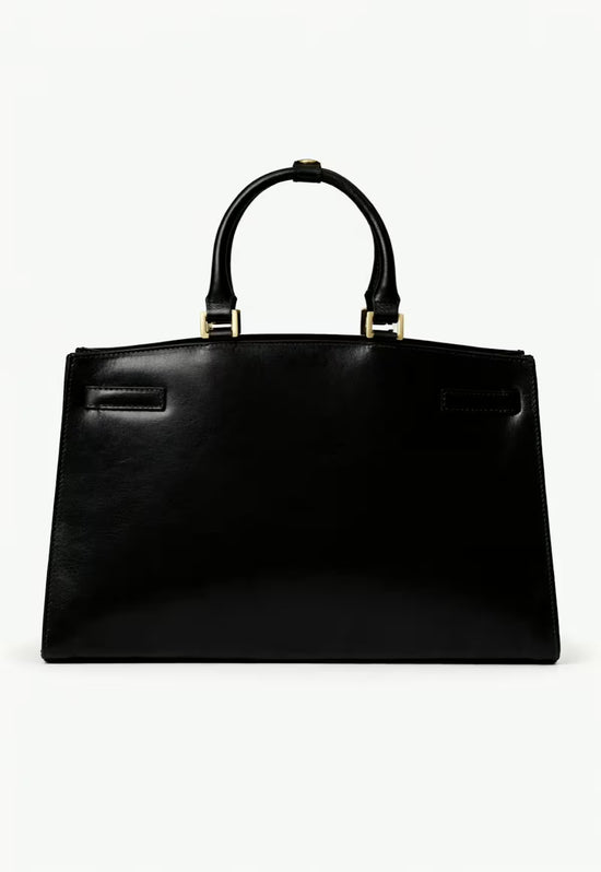 Black women's leather handbag shown from the back with a smooth rear panel and handles