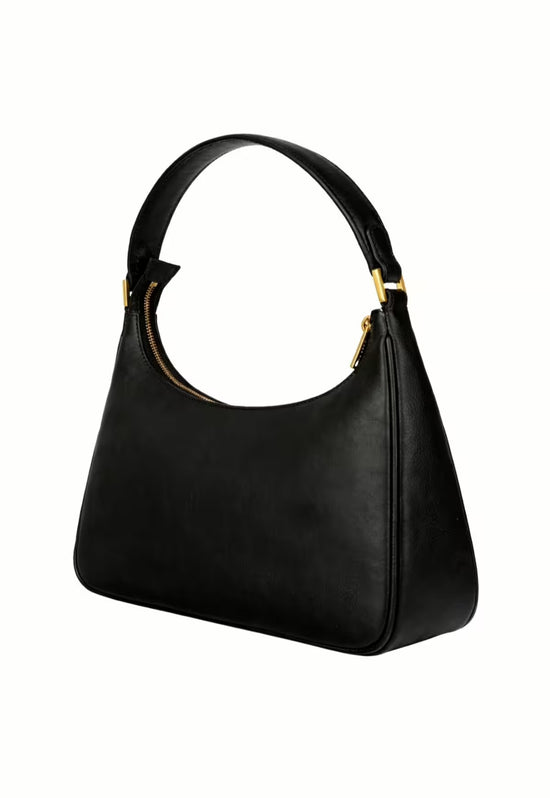 Black women’s leather handbag in an angled side view with gold-tone details