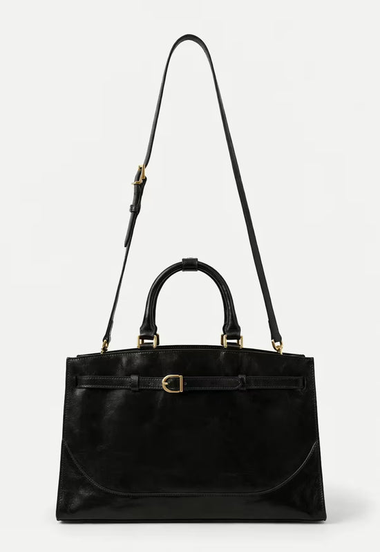 Black women's leather handbag shown from the front with a detachable shoulder strap