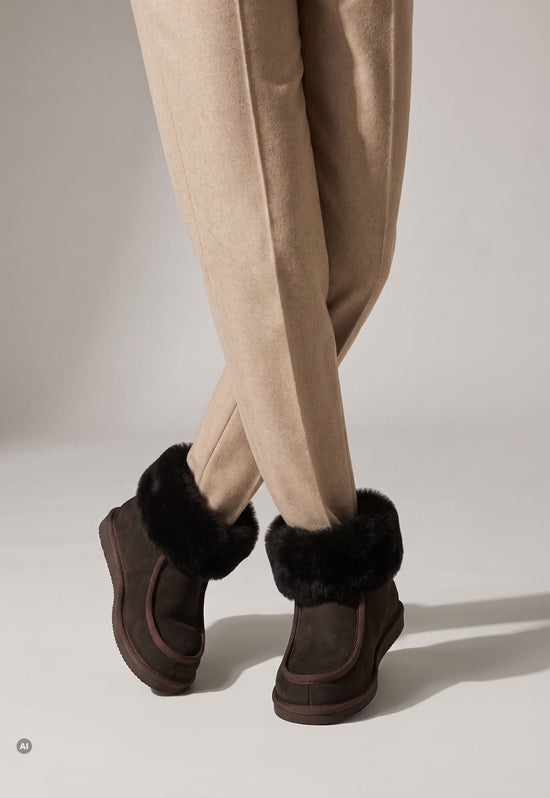 Ladies' sheepskin and suede slippers in brown, worn from the back with fur cuffs.