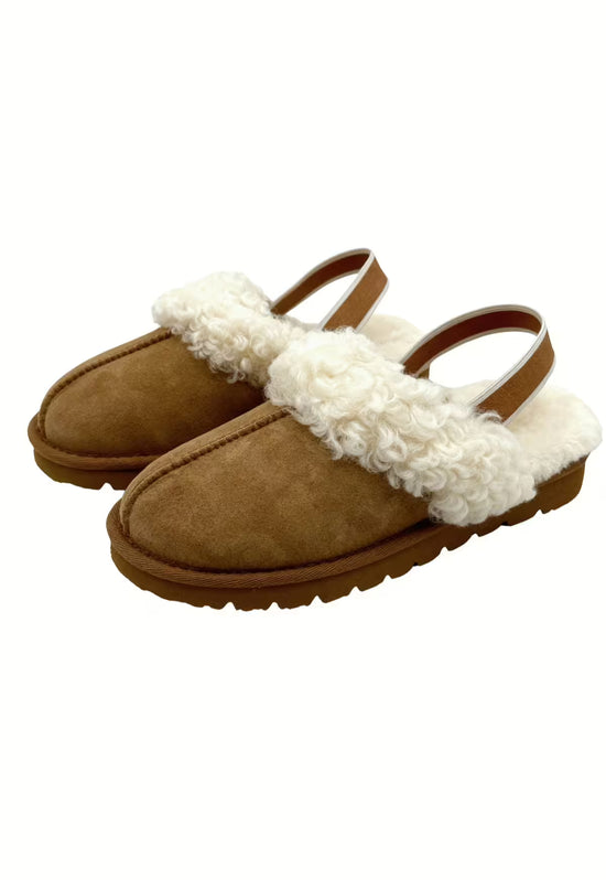 Brown pair of women's sheepskin slippers shown in an angled front view, isolated on white.