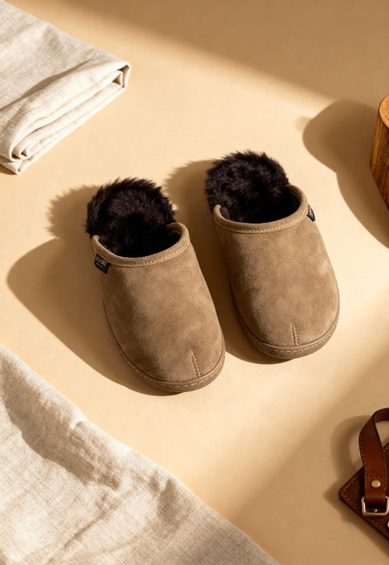 Men’s suede slippers with sheepskin, shown from above as a pair on a light surface.