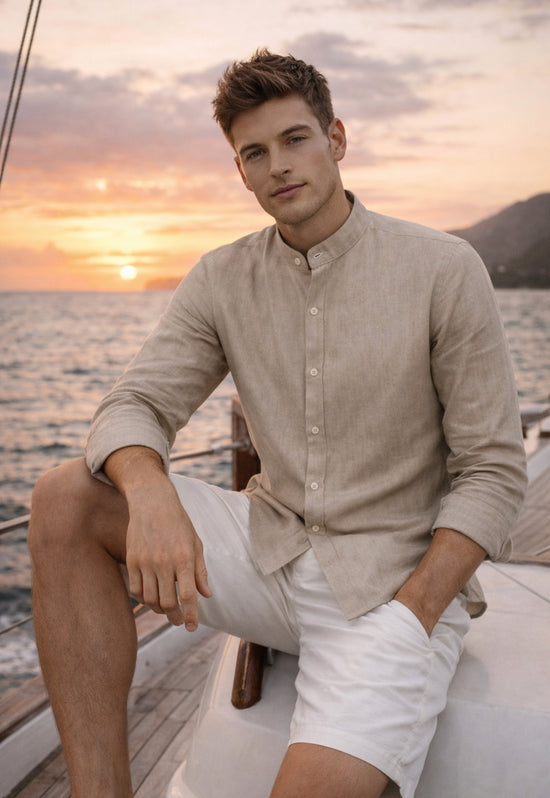 Beige men’s linen shirt worn on a boat with a light shorts look at sunset.