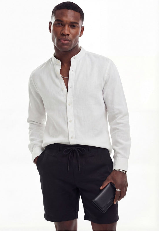 White men's linen shirt worn on a male model with shorts and a visible button placket.