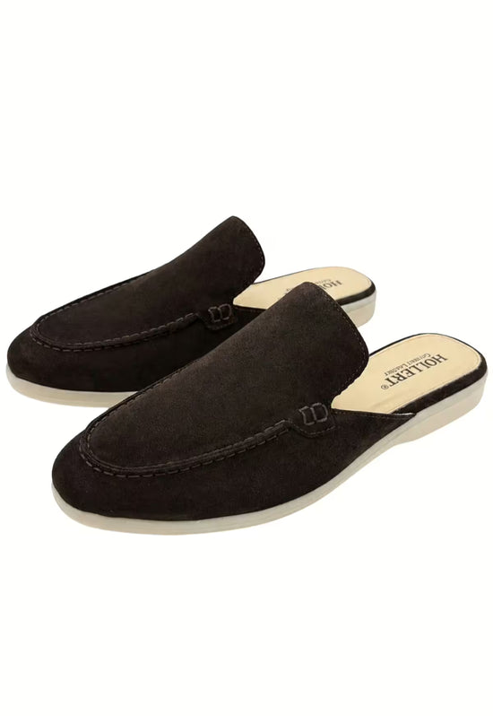 Two men's slippers in black calf suede shown in an angled pair view.