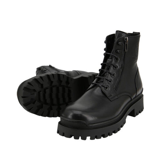 Black men's sheepskin shoe in an angled view with visible lug sole and lacing