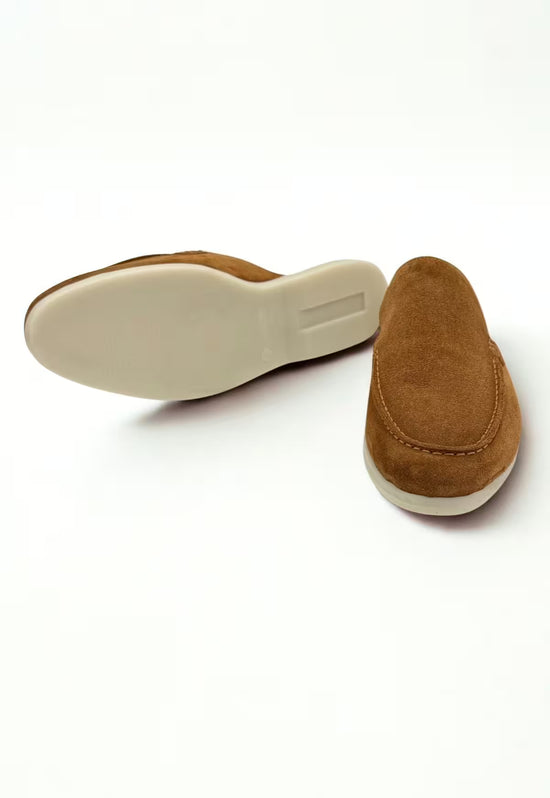 Men's slip-on shoe in whisky brown leather with a flat light sole, shown from below and the side.