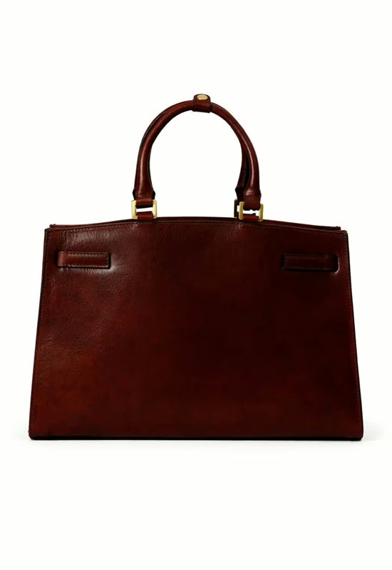 Brown leather hobo bag seen from the back with two handle attachments and a smooth back panel.