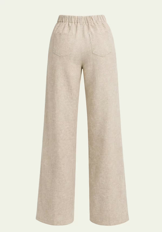 Back view of the beige women's linen trousers with patch back pockets and wide legs.