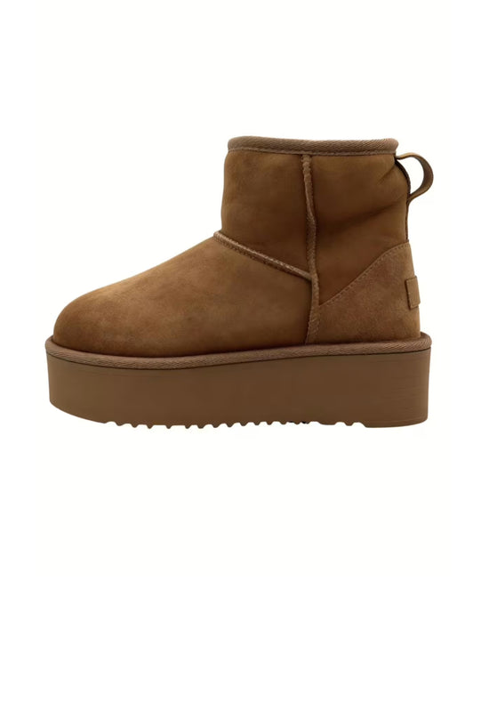 Brown sheepskin boot shown from the side with a platform sole and heel loop.