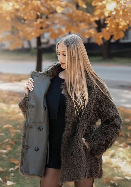 Open curly sheepskin jacket in olive, showing the inner side and button placket.