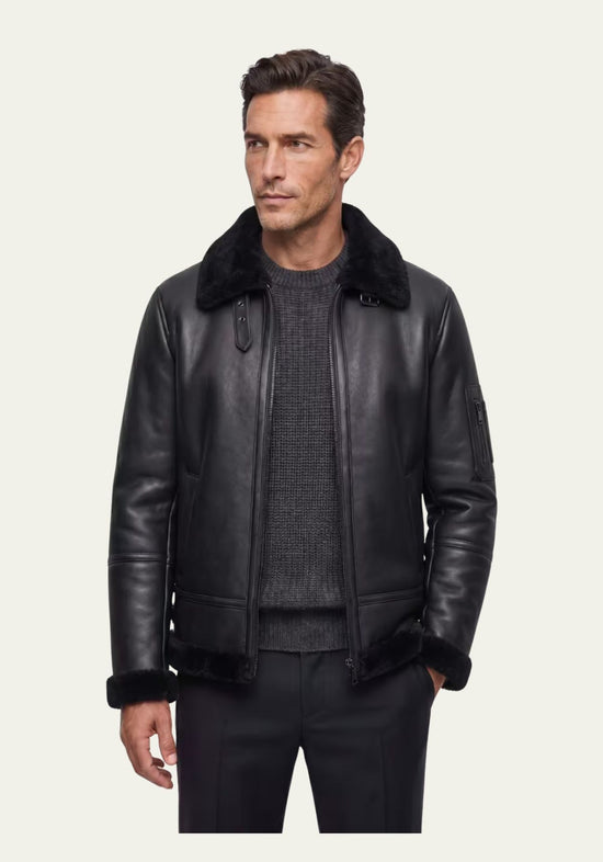 Black men's sheepskin jacket worn on a model, left open with a visible collar and straight cut.