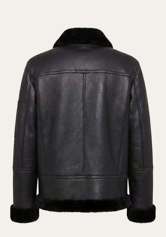 Cut-out rear view of the black men's sheepskin jacket with a wide trim at the hem.