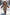 Child wearing a beige sheepskin jacket with hood and fur trim while walking in the snow