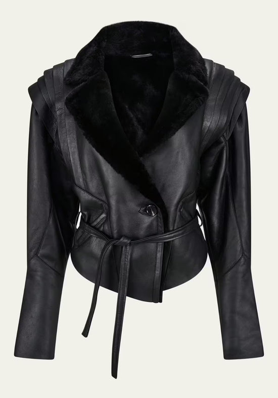 Black women's sheepskin jacket shown from the front with a belted waist and wide collar.