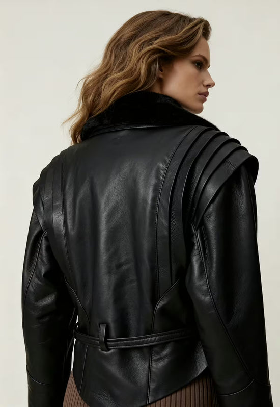 Half-back view of the black women's sheepskin jacket with belt and structured shoulder detail.
