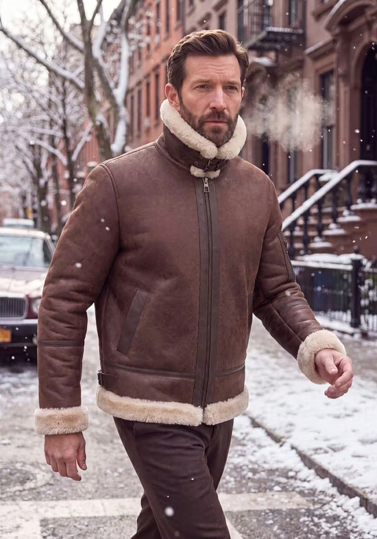 Men's sheepskin jacket in mahogany worn outdoors, front view with a light collar.