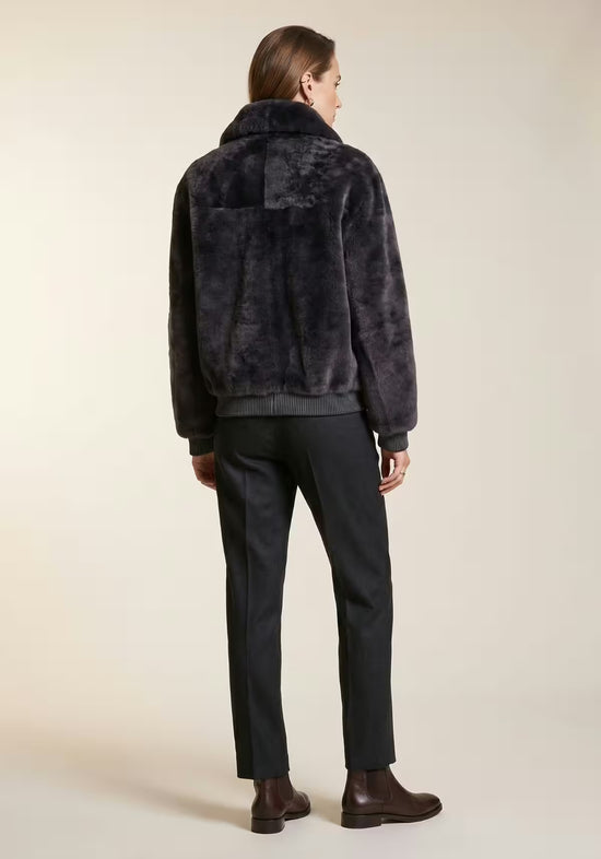 Women's shearling sheepskin jacket in anthracite, worn on a model from the back