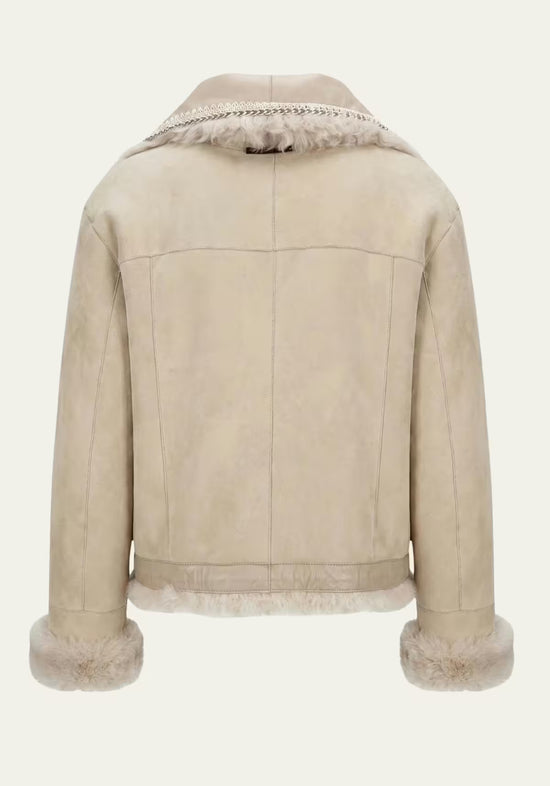 Sheepskin jacket for women in beige, shown from the back with suede, a straight back and fur hem.