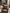 Sheepskin cushion in cappuccino on an armchair in a living room