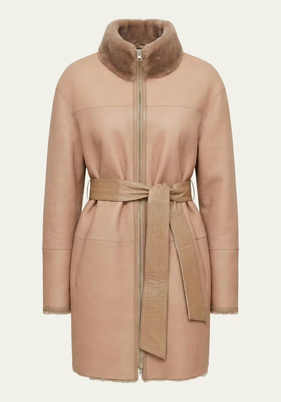 Beige women's sheepskin coat shown from the front, with zip fastening and belt tie.