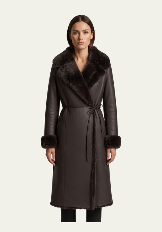 Brown sheepskin coat for women worn by a model from the front, with wide fur collar and turned cuffs.