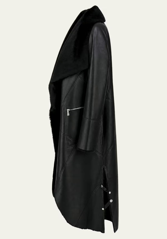 Side detail view of the black sheepskin coat with leather surface and side slit.