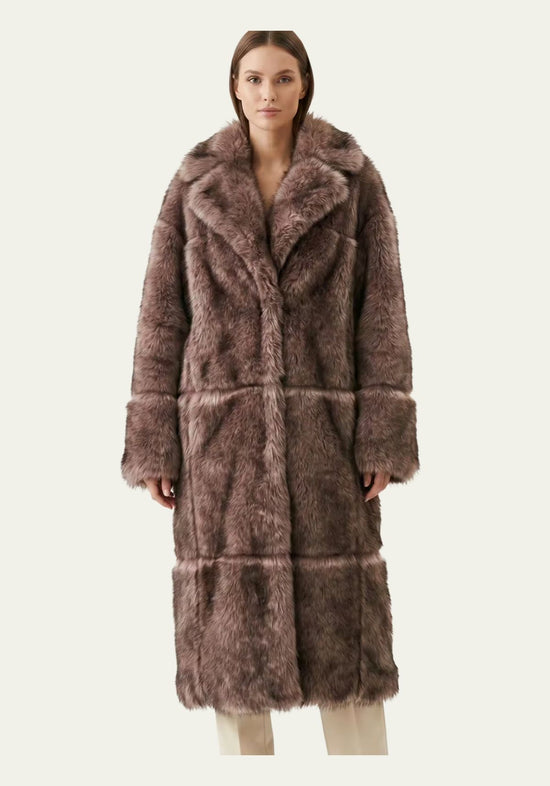 Women’s sheepskin coat in taupe on a model from the front, with a wide collar and a smooth silhouette.