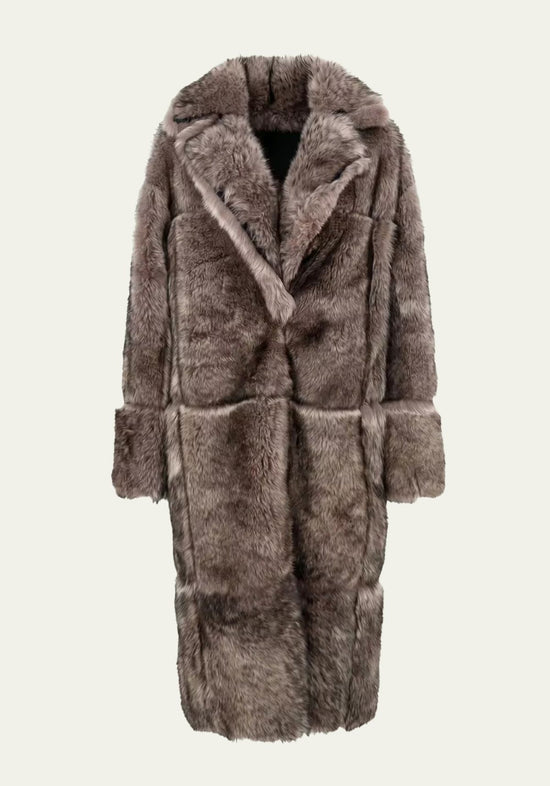 Freestanding women’s sheepskin coat in taupe, shown from the front with wide lapels and a long cut.