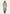 Women's sheepskin coat in beige, front view with fur collar, belt and trimmed cuffs.