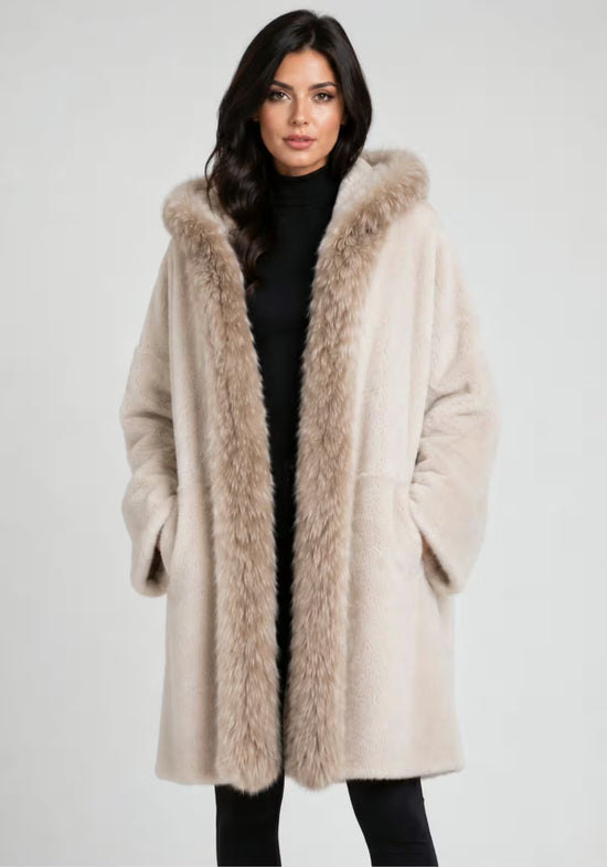 Cream women’s sheepskin coat on a model with the soft fur trim clearly visible.